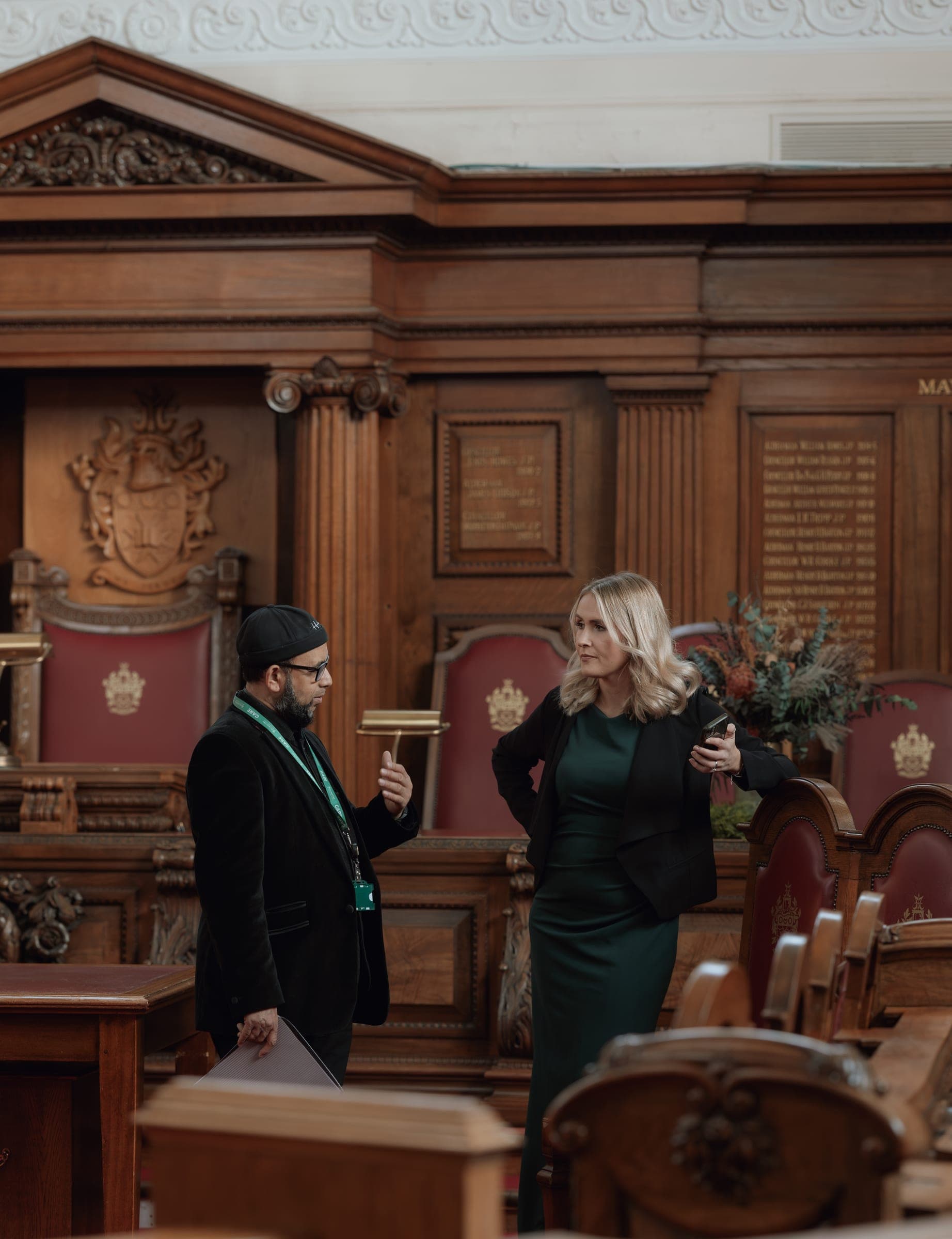 Guests gathered in a wood-panelled reception room